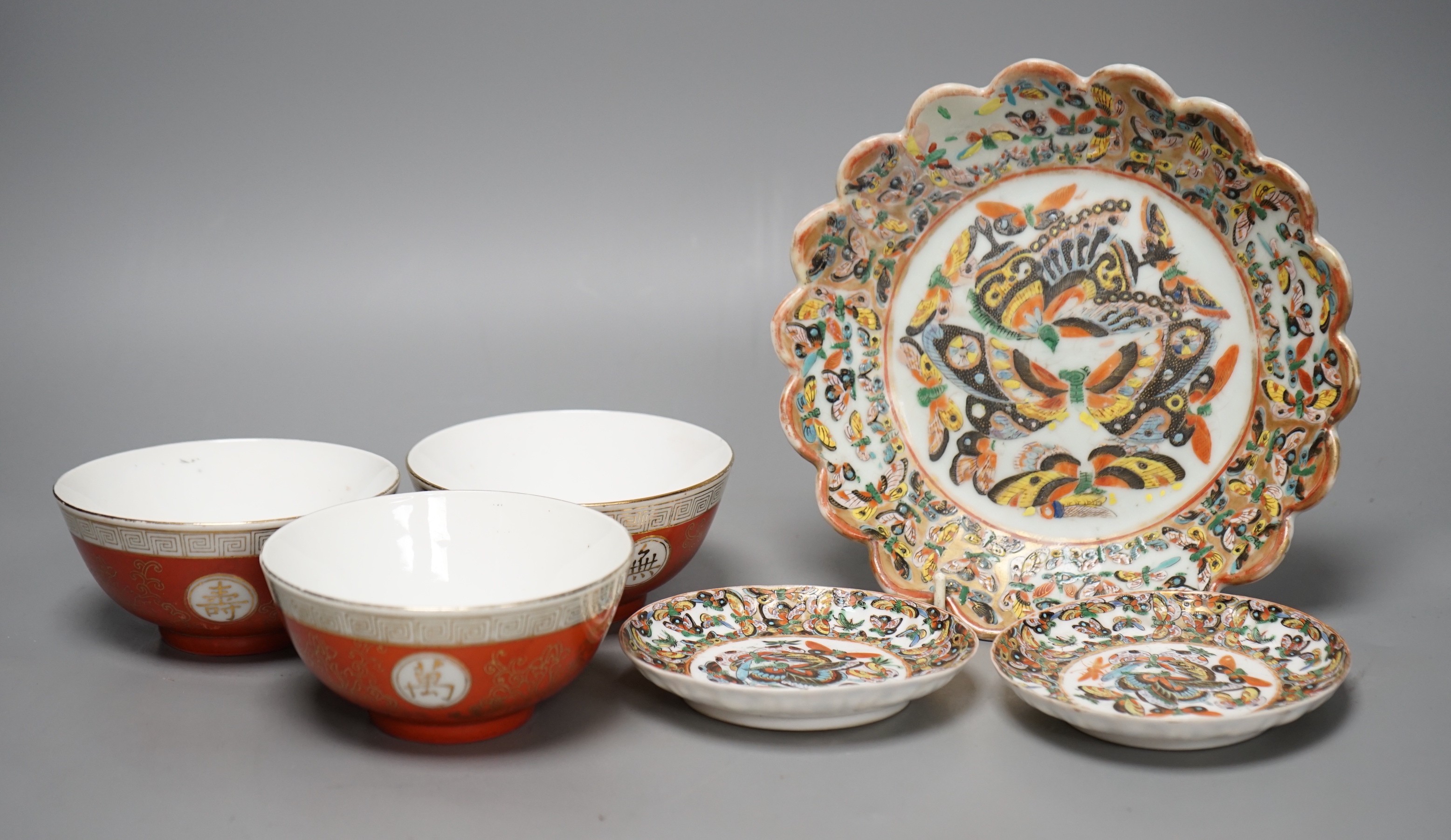 A Chinese 'thousand butterfly' dish and two saucers, early 20th century and three later Chinese coral round bowls, largest 20cm diameter